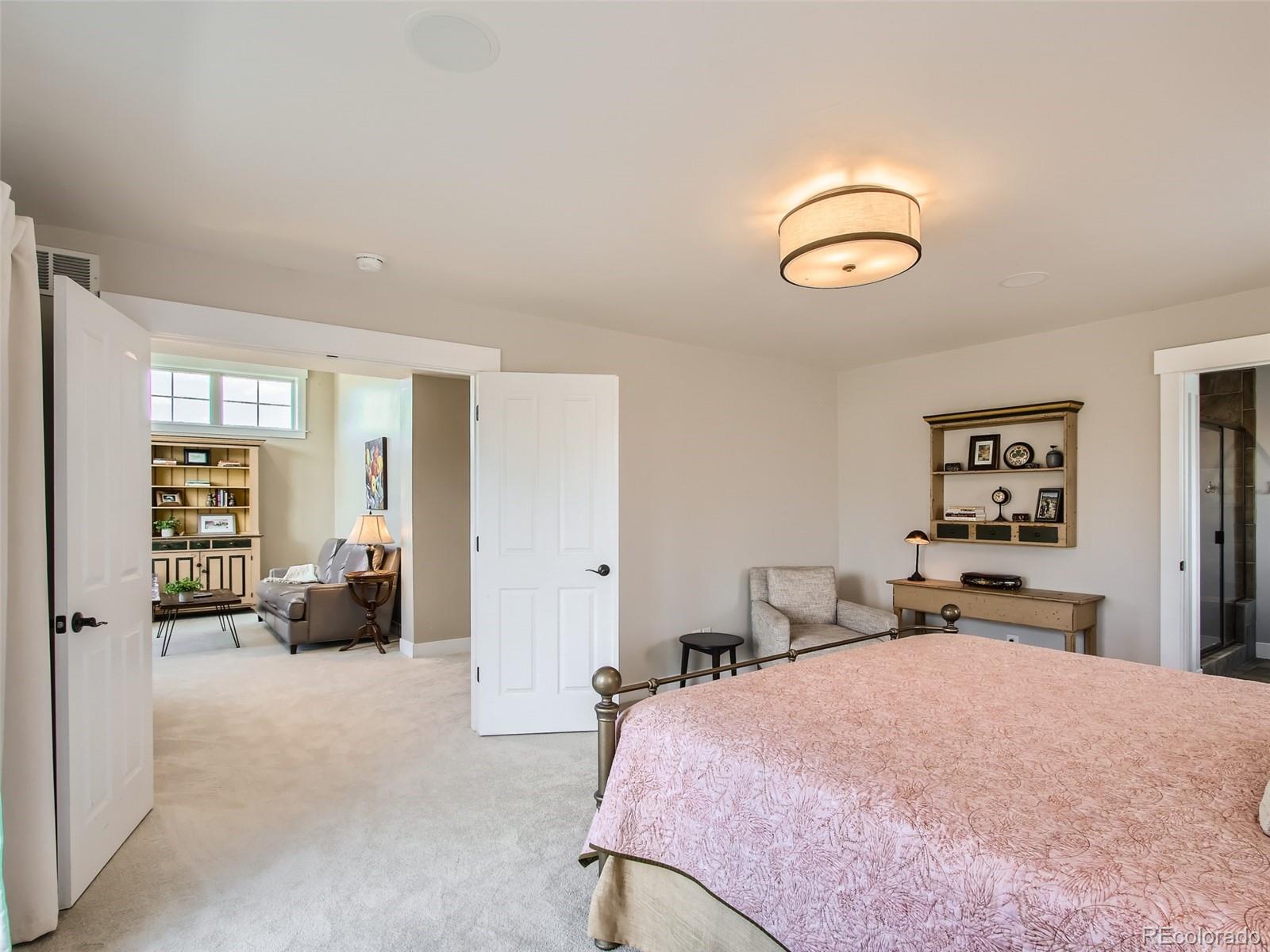 303 Alton Way Denver, CO 80230 - Photo 14 of 35 a bedroom with bed and furniture