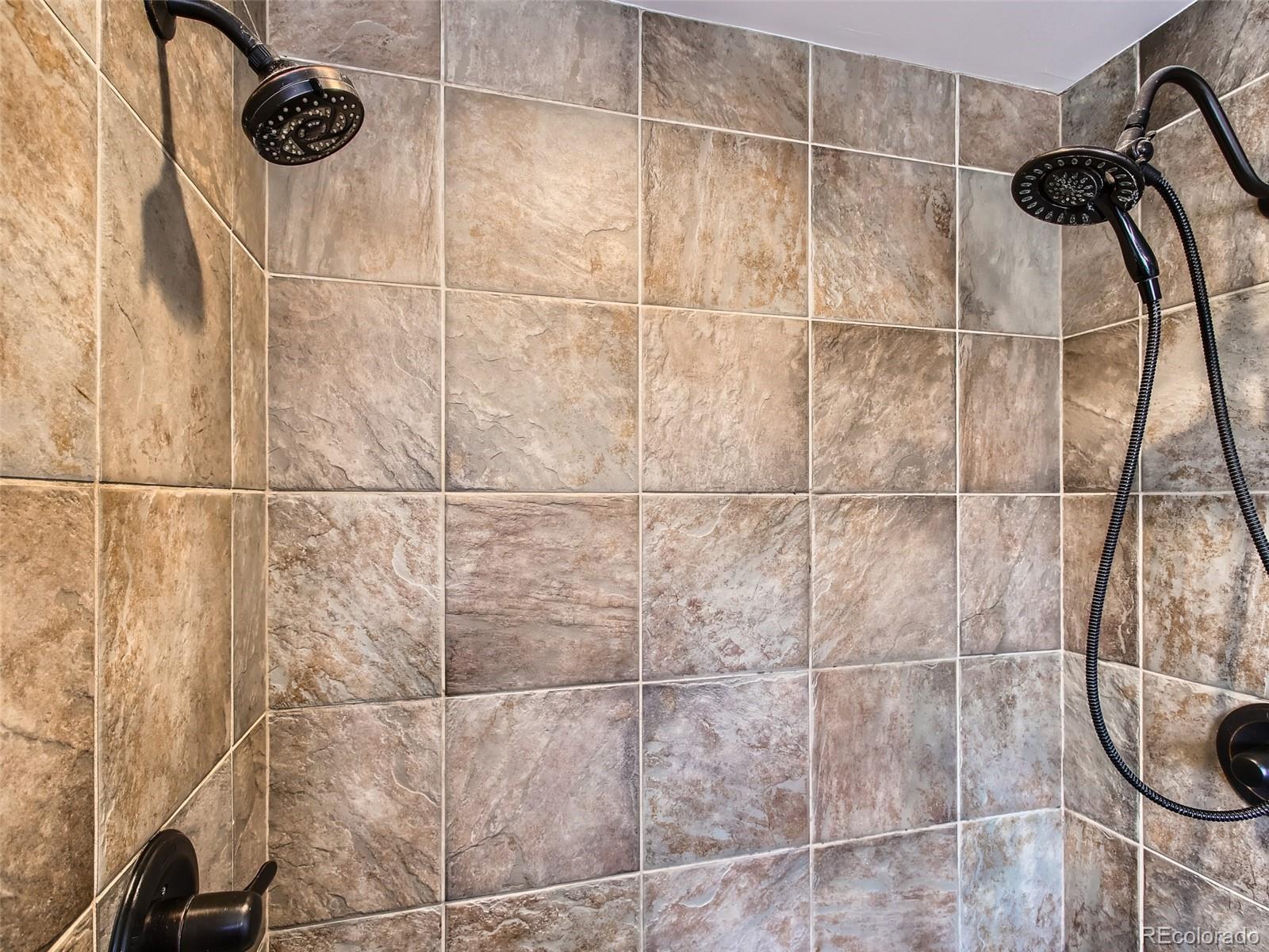 303 Alton Way Denver, CO 80230 - Photo 17 of 35 a bathroom with a shower