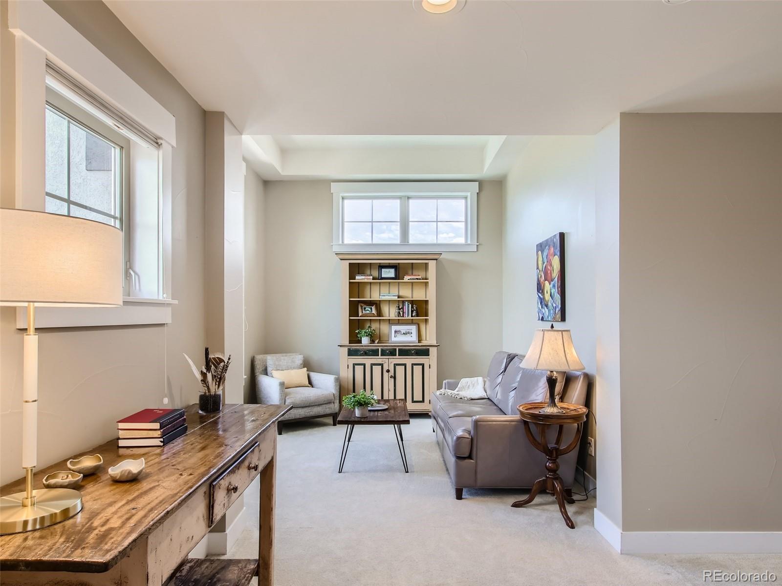 303 Alton Way Denver, CO 80230 - Photo 18 of 35 a living room with furniture and a window