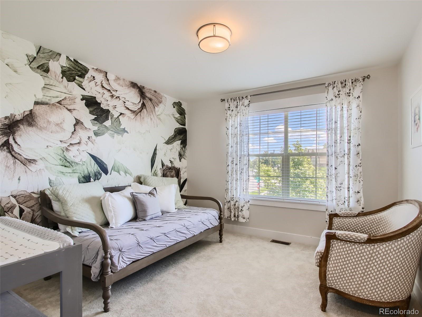 303 Alton Way Denver, CO 80230 - Photo 20 of 35 a bedroom with furniture and a window