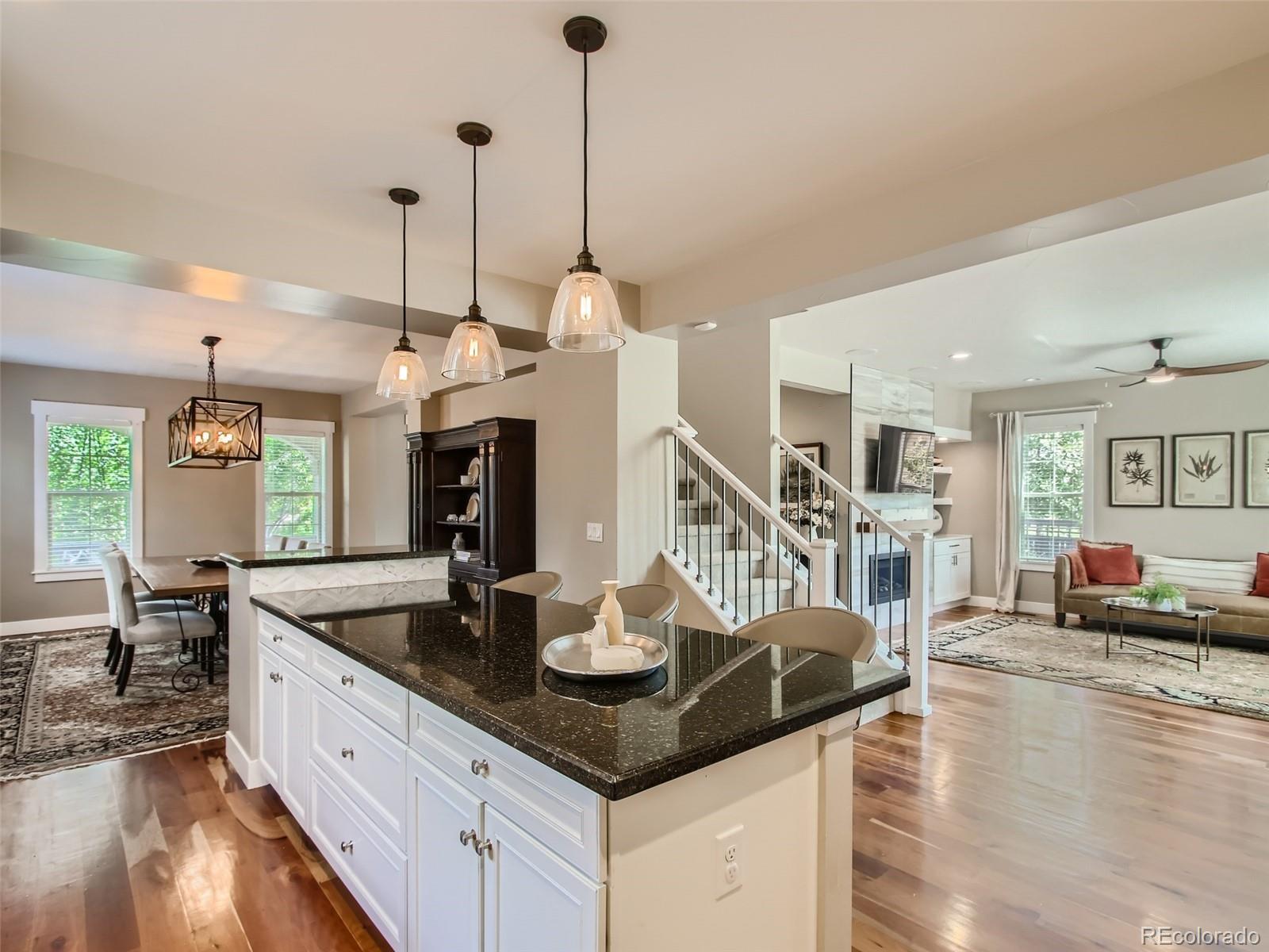 303 Alton Way Denver, CO 80230 - Photo 2 of 35 a kitchen with counter top space and living room