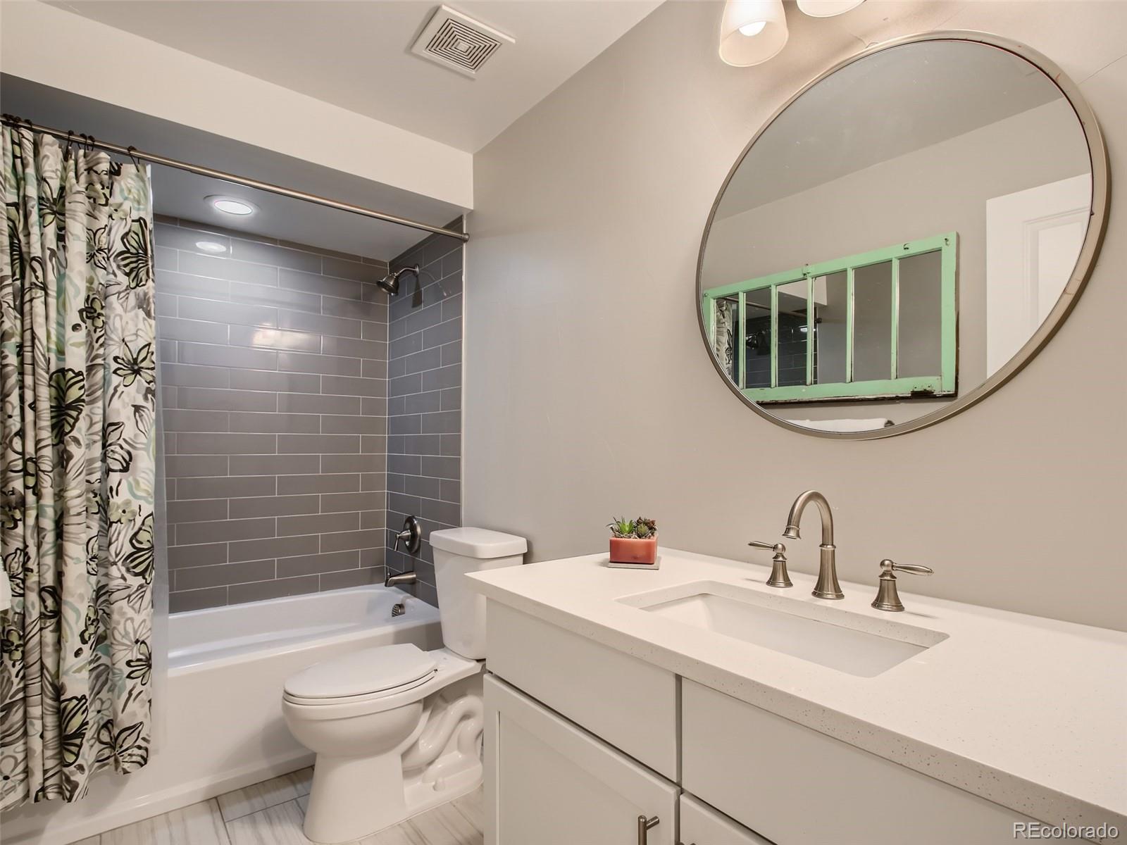 303 Alton Way Denver, CO 80230 - Photo 23 of 35 a bathroom with a sink toilet and shower