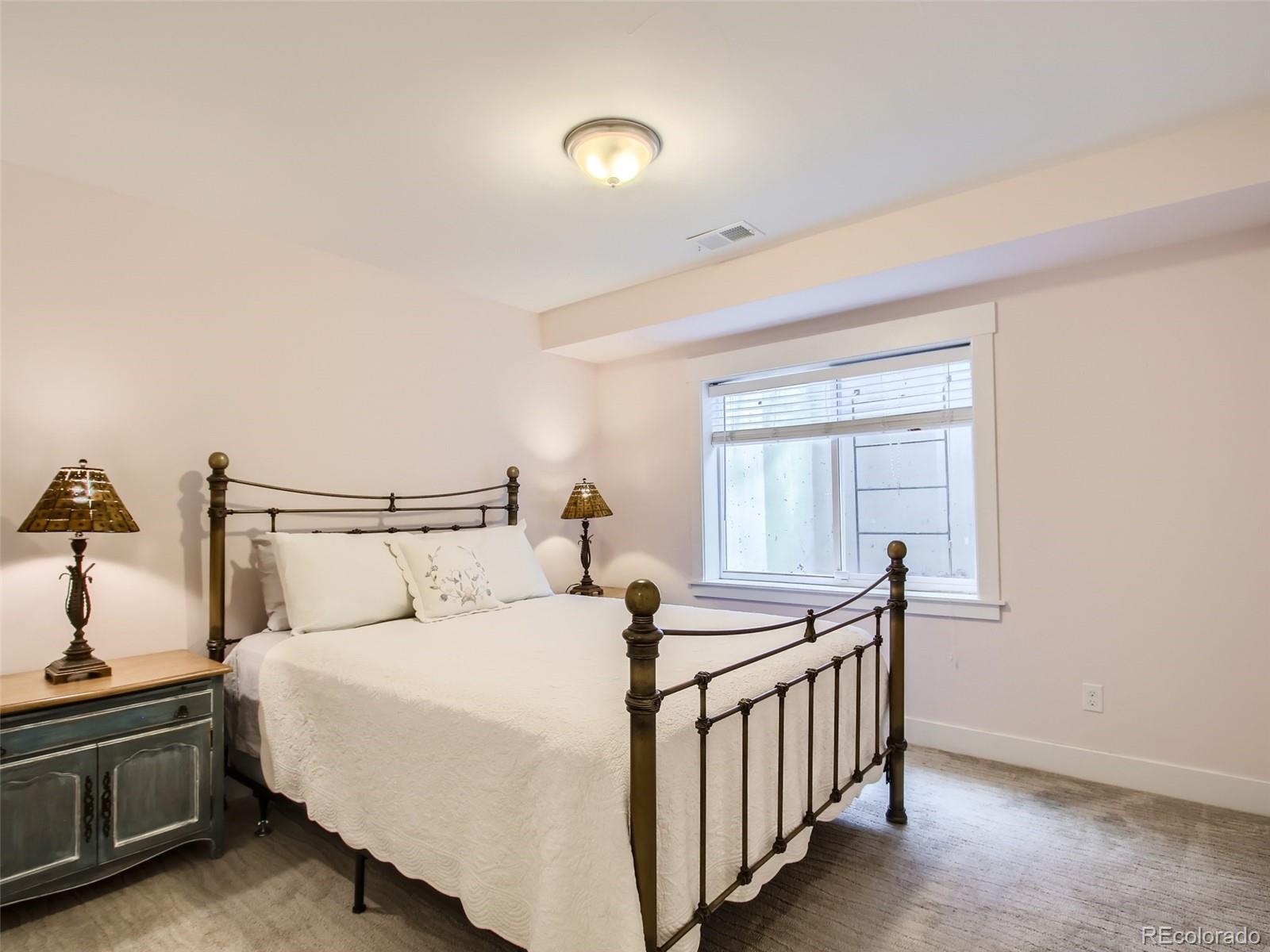 303 Alton Way Denver, CO 80230 - Photo 24 of 35 a bedroom with a bed and a window