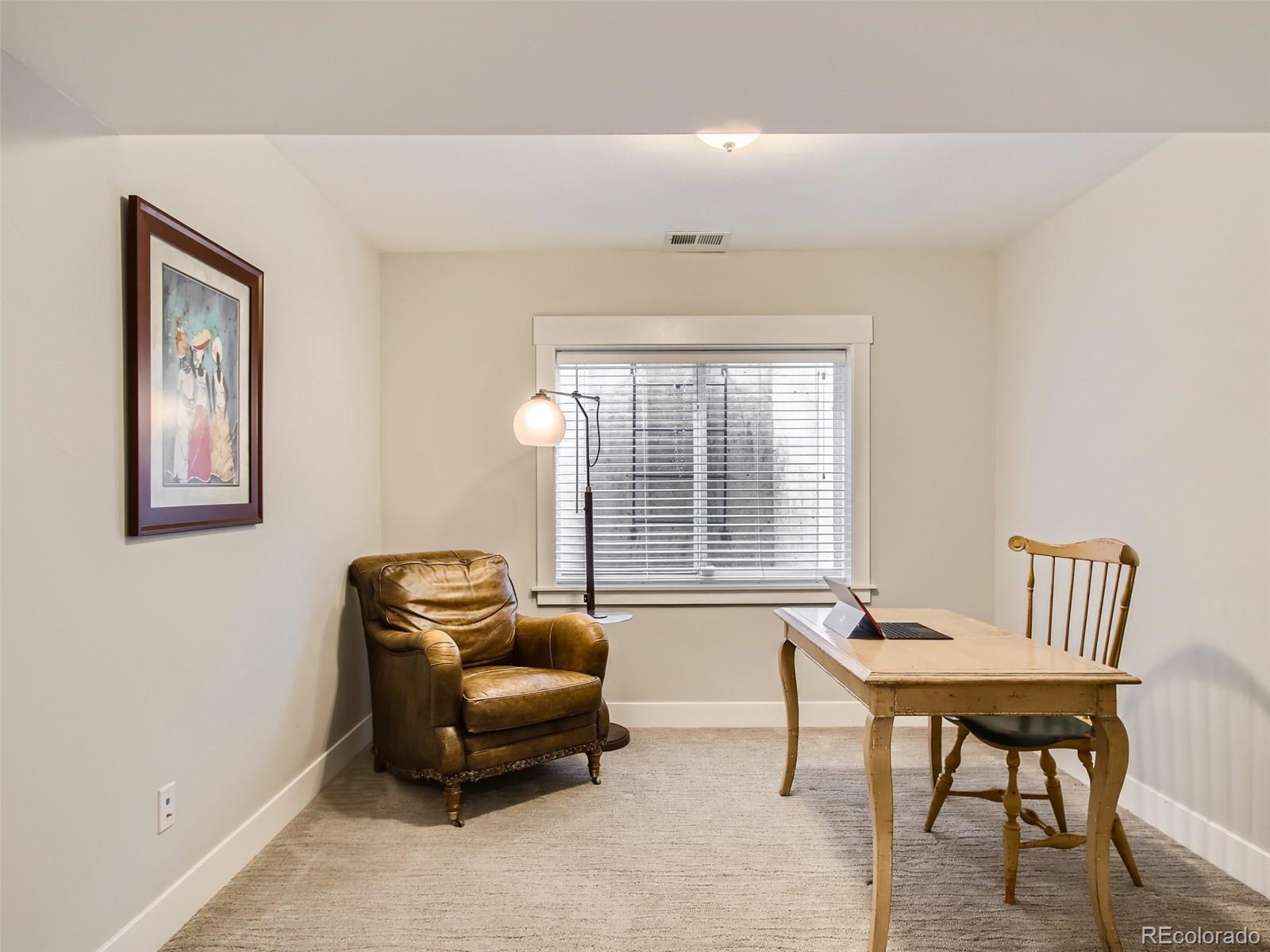 303 Alton Way Denver, CO 80230 - Photo 25 of 35 a living room with furniture and a window