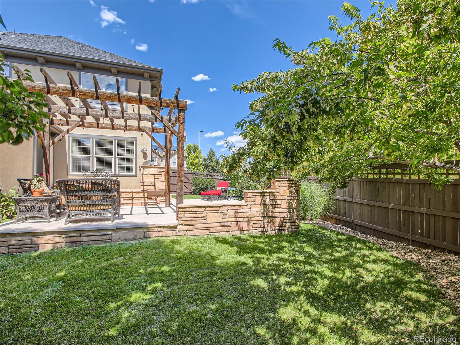 303 Alton Way Denver, CO 80230 - Photo 27 of 35 a front view of a house with a yard