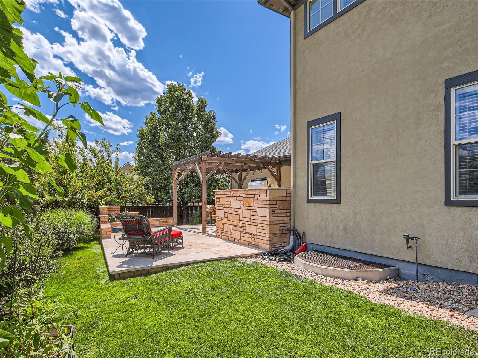 303 Alton Way Denver, CO 80230 - Photo 28 of 35 a backyard of a house with table and chairs