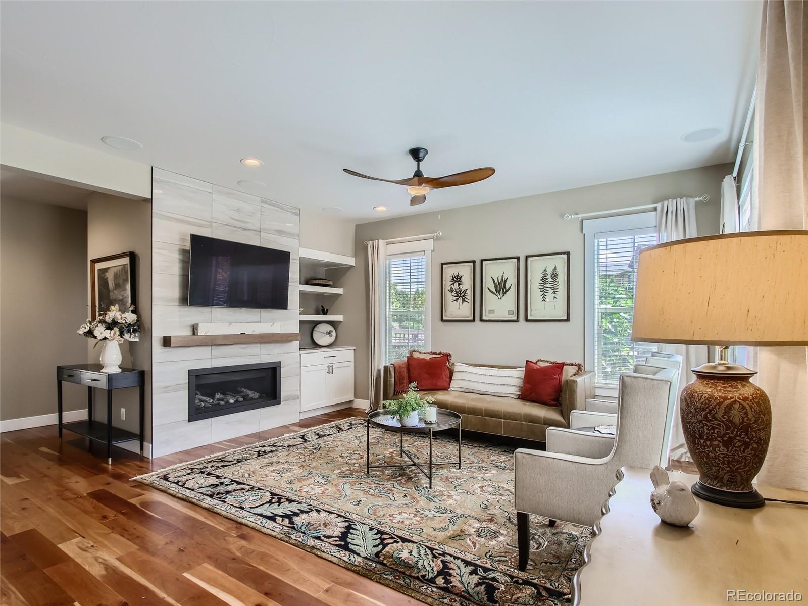303 Alton Way Denver, CO 80230 - Photo 4 of 35 a living room with furniture and a flat screen tv
