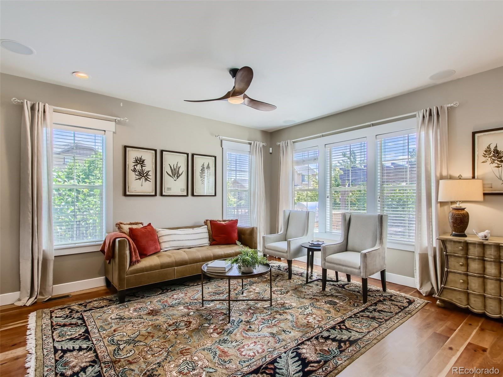 303 Alton Way Denver, CO 80230 - Photo 8 of 35 a living room with furniture and a rug