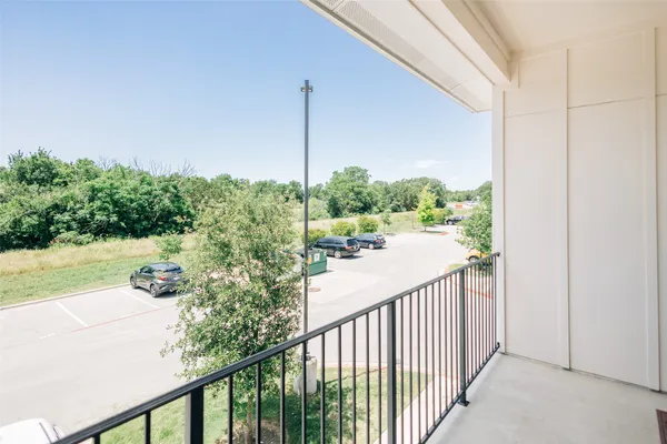 a view of a balcony with yard