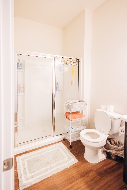 8601 West Gate Boulevard, Unit 4203 Austin, TX 78745 - Photo 10 of 15 Full bath with wood finished floors, a shower stall, and toilet