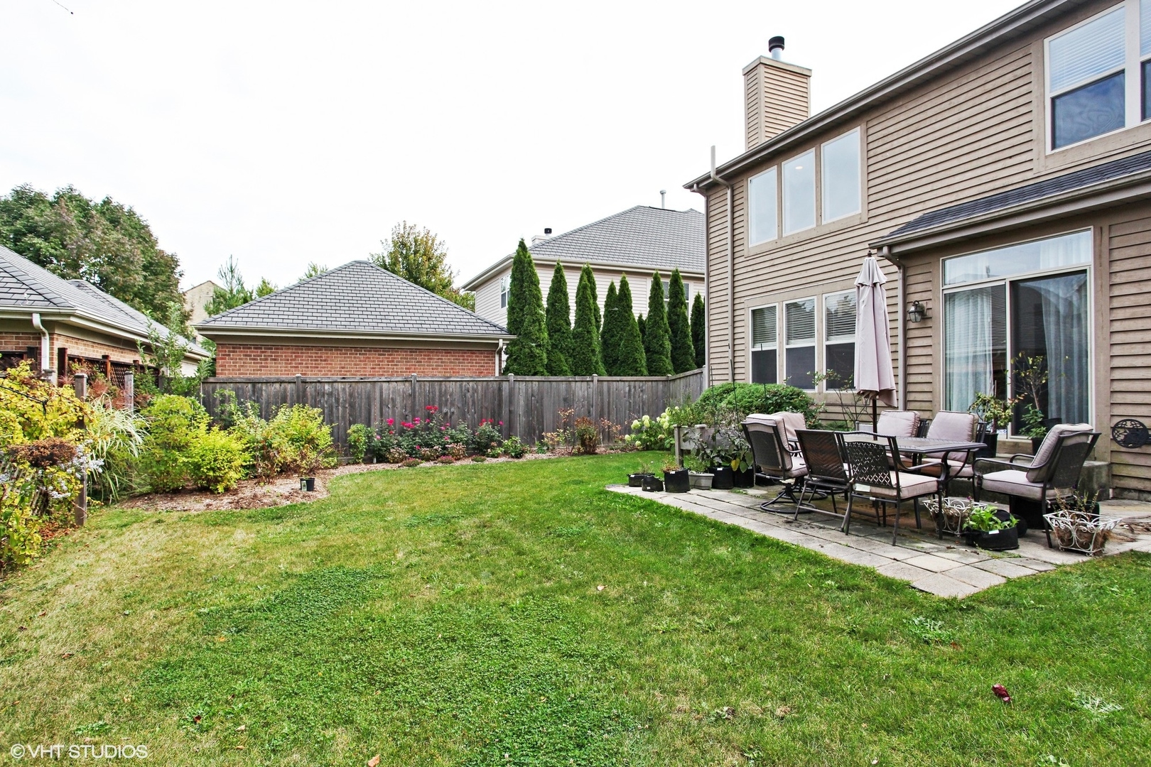 800 De Roo Loop Highwood, IL 60040 - Photo 15 of 22 a view of a house with backyard sitting area and garden