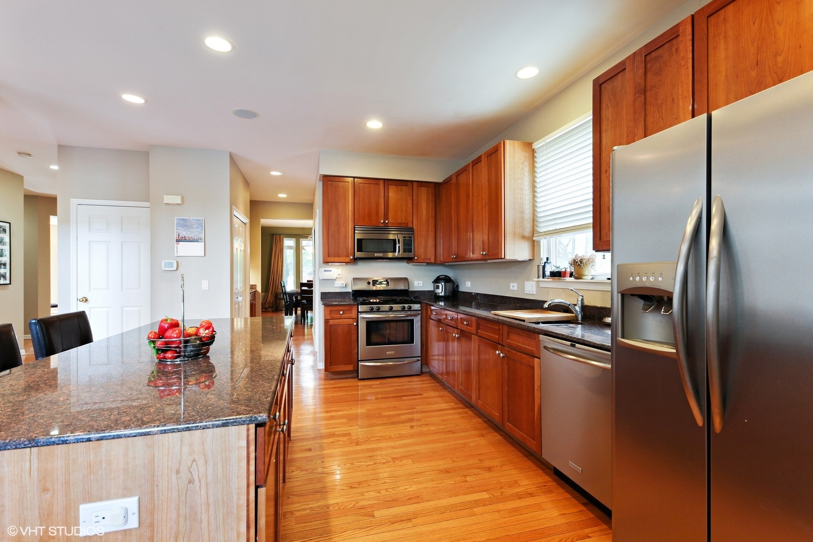 800 De Roo Loop Highwood, IL 60040 - Photo 3 of 22 a kitchen with stainless steel appliances granite countertop a refrigerator a sink dishwasher with a dining table and chairs
