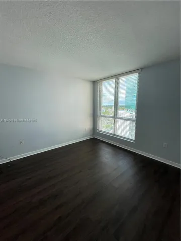 a view of wooden floor and windows in a room
