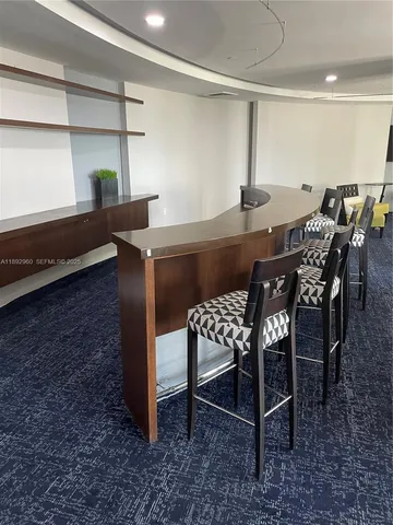 a dining room with a table and chairs