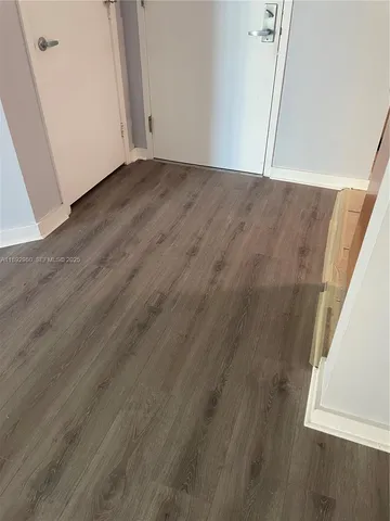 an empty room with wooden floor