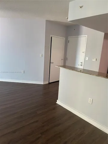 an empty room with wooden floor