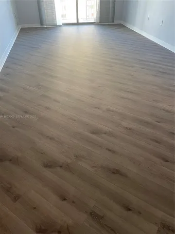 a view of a room with wooden floor