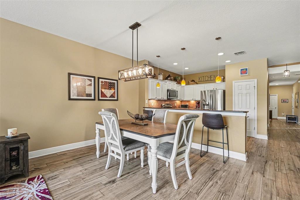 2134 Barracuda Court Holiday, FL 34691 - Photo 11 of 36 a view of a dining room with furniture wooden floor and chandelier