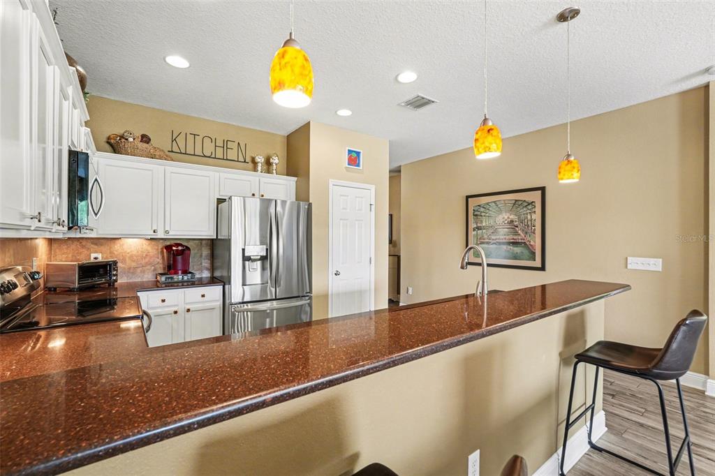 2134 Barracuda Court Holiday, FL 34691 - Photo 14 of 36 a kitchen with stainless steel appliances granite countertop a sink and a refrigerator