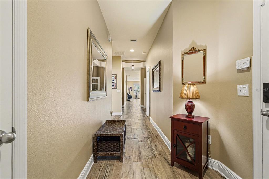 2134 Barracuda Court Holiday, FL 34691 - Photo 16 of 36 a view of a hallway with wooden floor and a bathroom