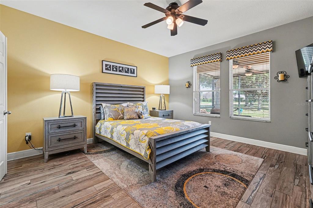 2134 Barracuda Court Holiday, FL 34691 - Photo 18 of 36 a bedroom with a bed and a chandelier