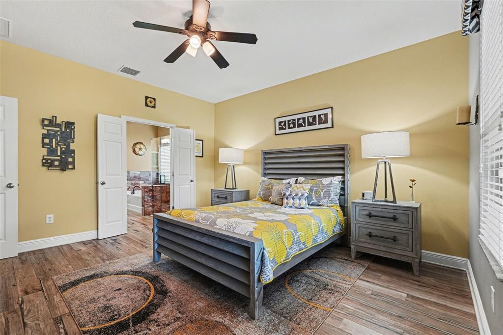2134 Barracuda Court Holiday, FL 34691 - Photo 19 of 36 a bedroom with a bed and a chandelier