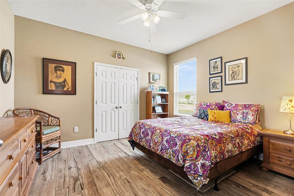 2134 Barracuda Court Holiday, FL 34691 - Photo 21 of 36 a bedroom with a bed and a chandelier