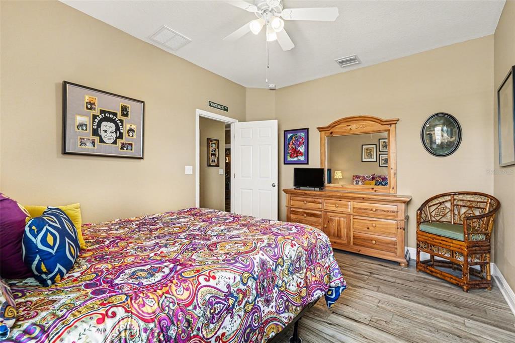 2134 Barracuda Court Holiday, FL 34691 - Photo 22 of 36 a bedroom with a bed and a chandelier