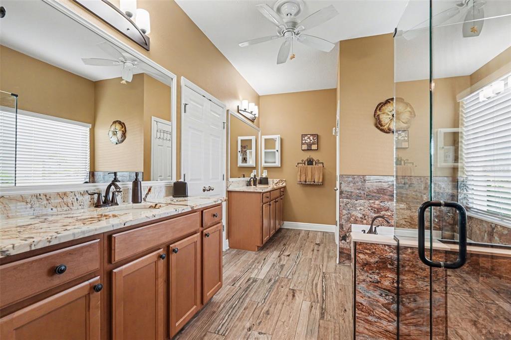 2134 Barracuda Court Holiday, FL 34691 - Photo 24 of 36 a spacious bathroom with a granite countertop sink a mirror and shower