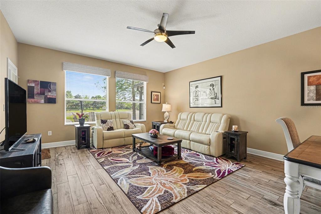 2134 Barracuda Court Holiday, FL 34691 - Photo 5 of 36 a living room with furniture a flat screen tv and a large window
