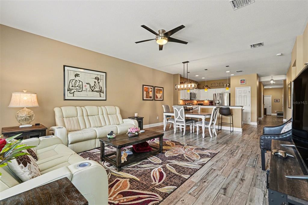 2134 Barracuda Court Holiday, FL 34691 - Photo 9 of 36 a living room with furniture a wooden floor and a ceiling fan