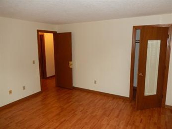 88-90 Beverly Lane Springfield, MA 01151 - Photo 5 of 6 an empty room with wooden floor and closet