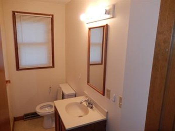 88-90 Beverly Lane Springfield, MA 01151 - Photo 6 of 6 a bathroom with a sink a toilet and mirror