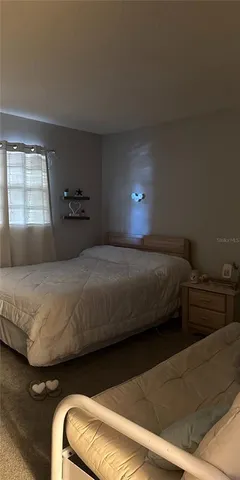 a bedroom with a bed and window