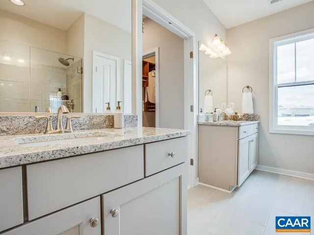 a bathroom with a sink double vanity and a mirror