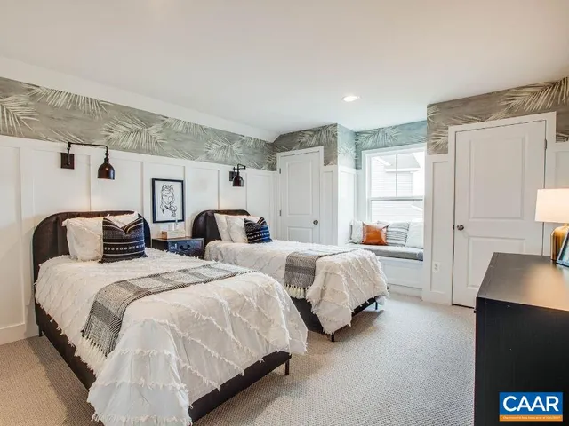 a large bedroom with two beds and a couch