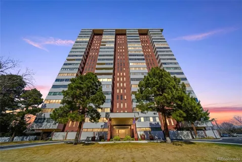a view of a large building with trees in the background