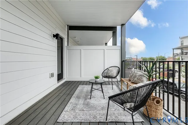 a patio with glass top table and chairs