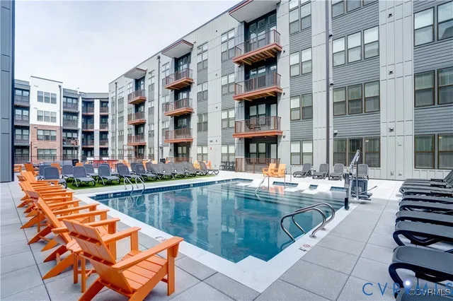 a living room with furniture a wooden floor and a large window