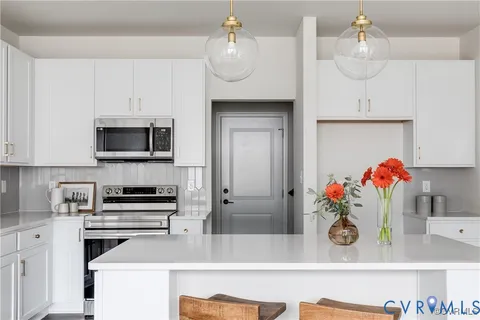 a kitchen with stainless steel appliances granite countertop a sink and a stove