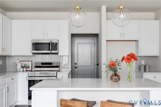 a kitchen with stainless steel appliances granite countertop a sink and a stove