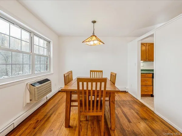 a dining room with furniture a chandelier and wooden floor