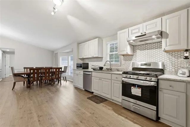 a view of a dining room with furniture and wooden floor