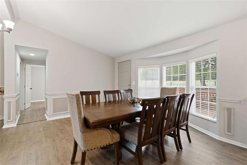 1295 Double Bridges Road Winder, GA 30680 - Photo 14 of 59 a view of a dining room with furniture and wooden floor