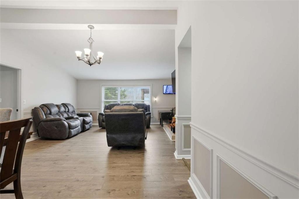 1295 Double Bridges Road Winder, GA 30680 - Photo 16 of 59 a living room with furniture and a chandelier