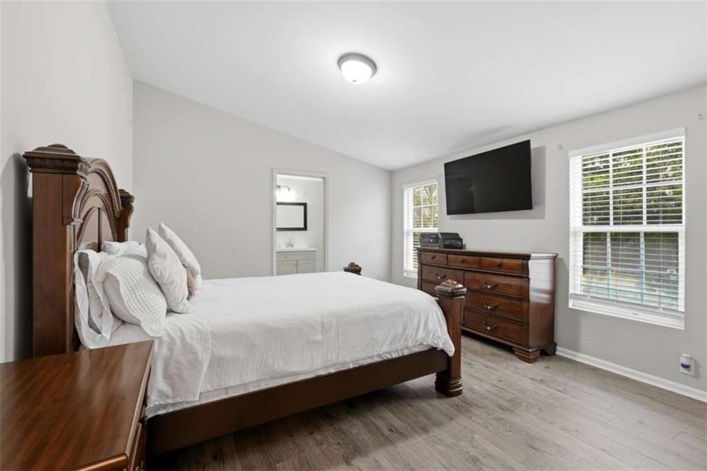 1295 Double Bridges Road Winder, GA 30680 - Photo 18 of 59 a bedroom with a bed and a flat screen tv