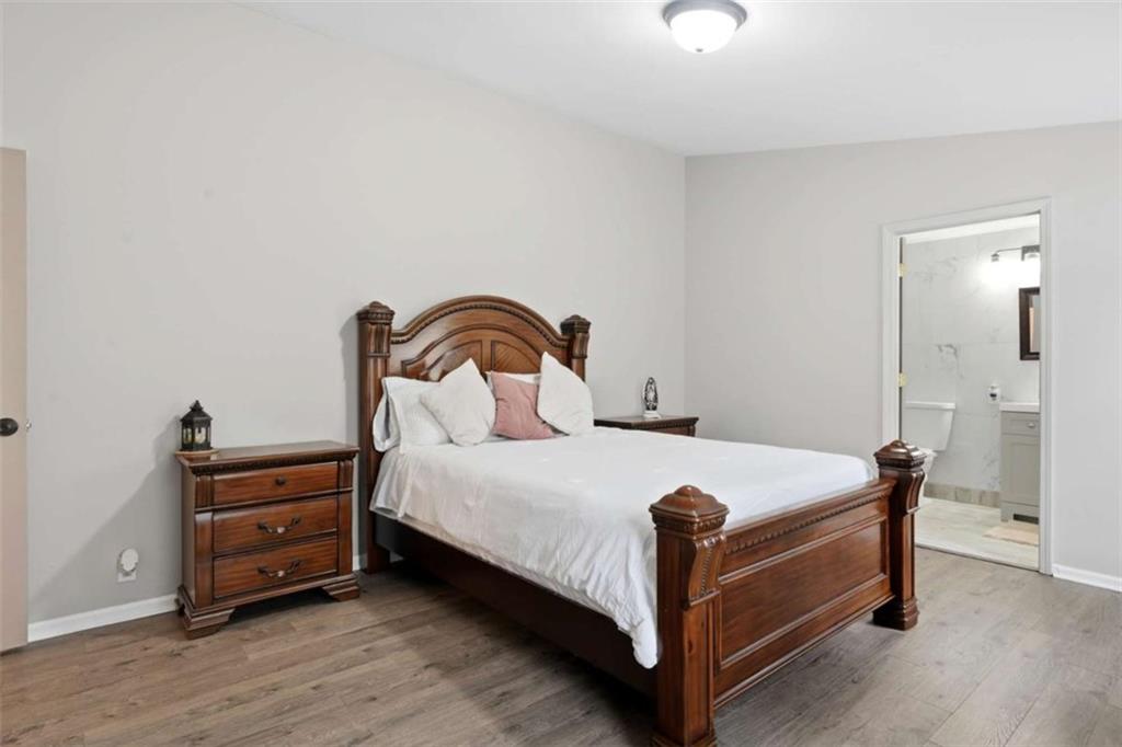 1295 Double Bridges Road Winder, GA 30680 - Photo 19 of 59 a bedroom with a bed and a dresser