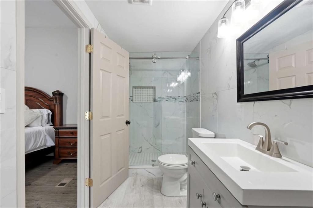 1295 Double Bridges Road Winder, GA 30680 - Photo 20 of 59 a bathroom with a sink a toilet and shower