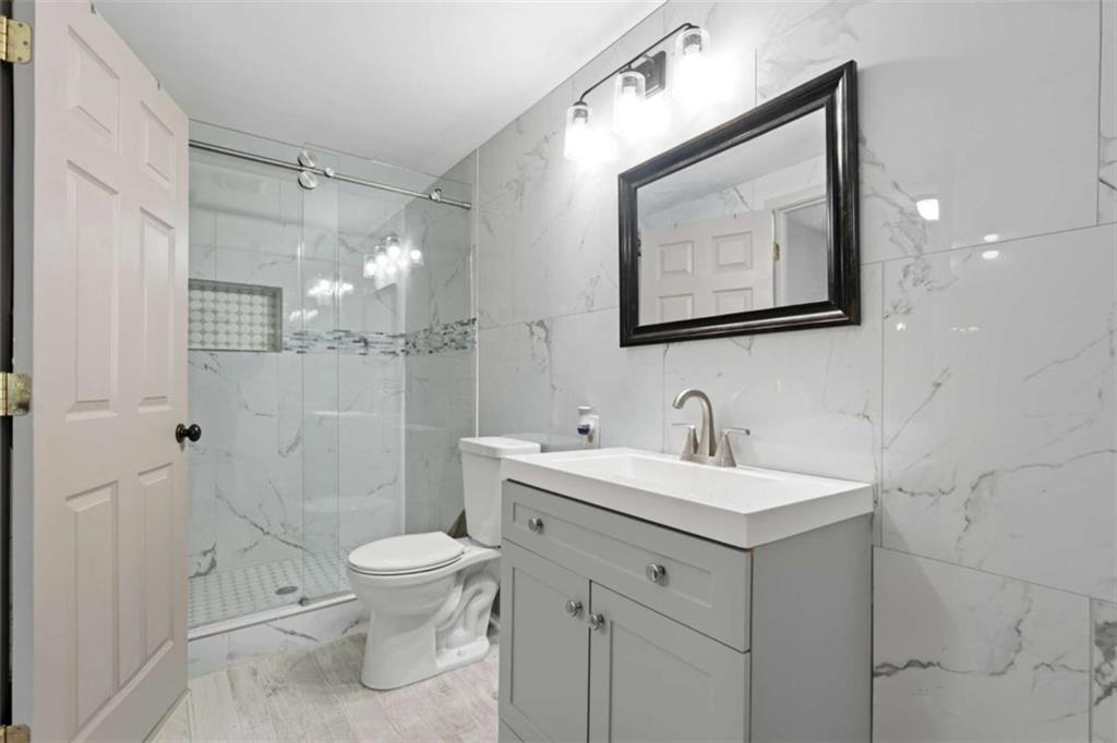 1295 Double Bridges Road Winder, GA 30680 - Photo 21 of 59 a bathroom with a toilet sink and mirror