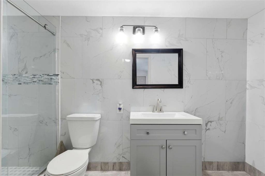 1295 Double Bridges Road Winder, GA 30680 - Photo 26 of 59 a bathroom with a toilet sink and mirror